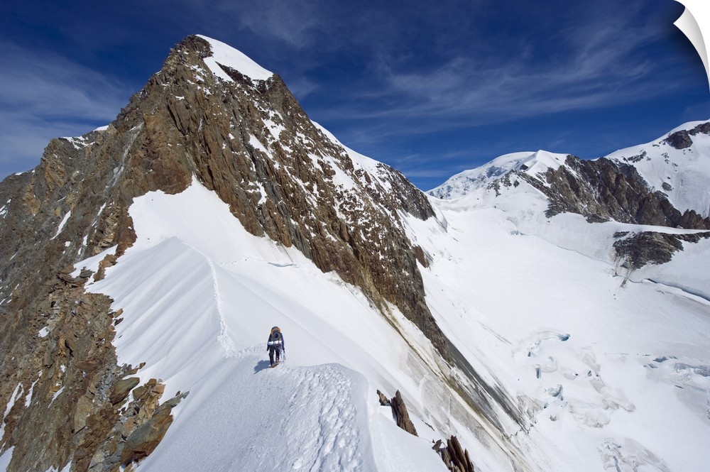 Climber on snow ridge, Aiguille de Bionnassay, French Alps, France