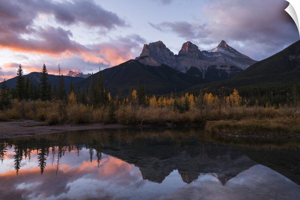 Colourful sunrise over Three Sisters at Policeman Creek in autumn, Canmore, Banff, Alberta, Canadian Rockies, Canada, Nort...