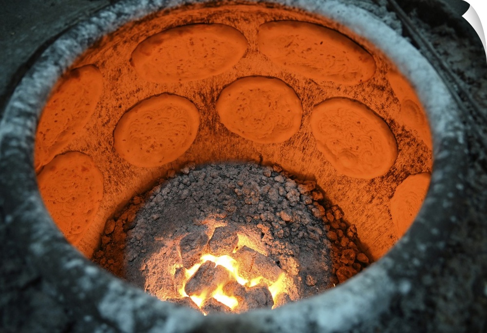 Flatbreads cooking in flatbread oven in Turfan street night market, Turfan, Xinjiang, China, Asia