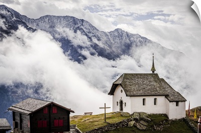 Foggy Sky Over The Small Church In The Alpine Village Of Bettmeralp, Switzerland