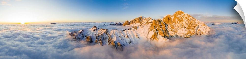 Panoramic aerial view of Grigne group mountain peaks emerging from mist at sunset, Lake Como, Lecco province, Lombardy, It...