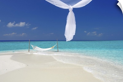 Hammock hanging in shallow clear water, The Maldives, Indian Ocean, Asia