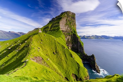 Kallur Lighthouse On Cliffs Covered With Grass With Borgarin Mountain Peak, Denmark