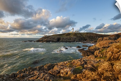 Killantringan Lighthouse On Black Head And Rocky Coastline At Sunset, Scotland
