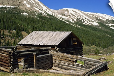 Log cabin at Independence town site, with Sawatch Mountains, Colorado, USA