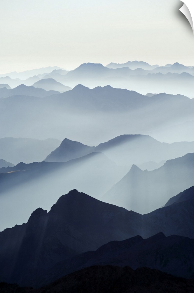 Mountains silhouetted at sunrise, view from Pico de Aneto, at 3404m the highest peak in the Pyrenees, Spain, Europe
