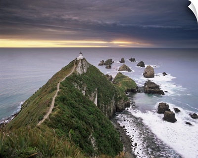 Nugget Point lighthouse on the coast and overcast sky, the Catlins, New Zealand