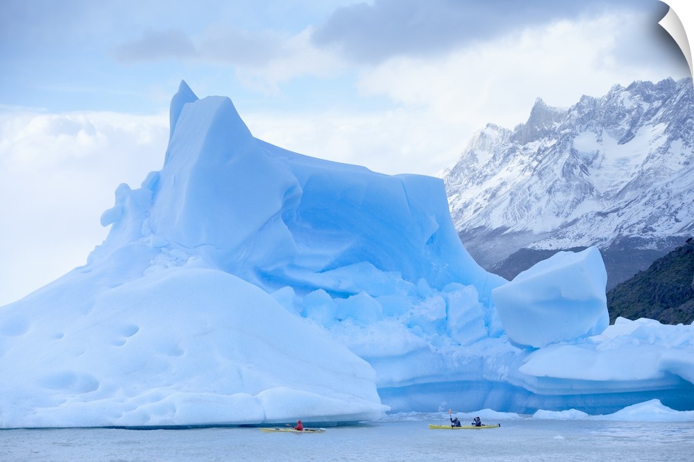 People kayaking near floating icebergs, Patagonian Andes, Chile