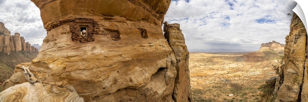 Aerial panoramic by drone of priest looking out from Abuna Yemata Guh rock-hewn church, Gheralta Mountains, Tigray region,...