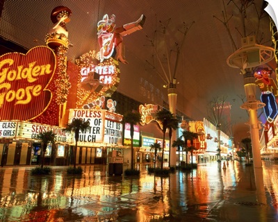 Reflections on wet street of neon signs along Fremont Street in Las Vegas, Nevada