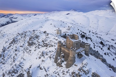 Rocca Calascio Castle And The Santa Maria Della Pieta Church In A Snowy Landscape, Italy