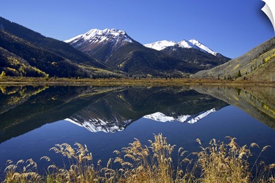Snow-capped Red Mountain reflected in Crystal Lake with fall colors, Colorado