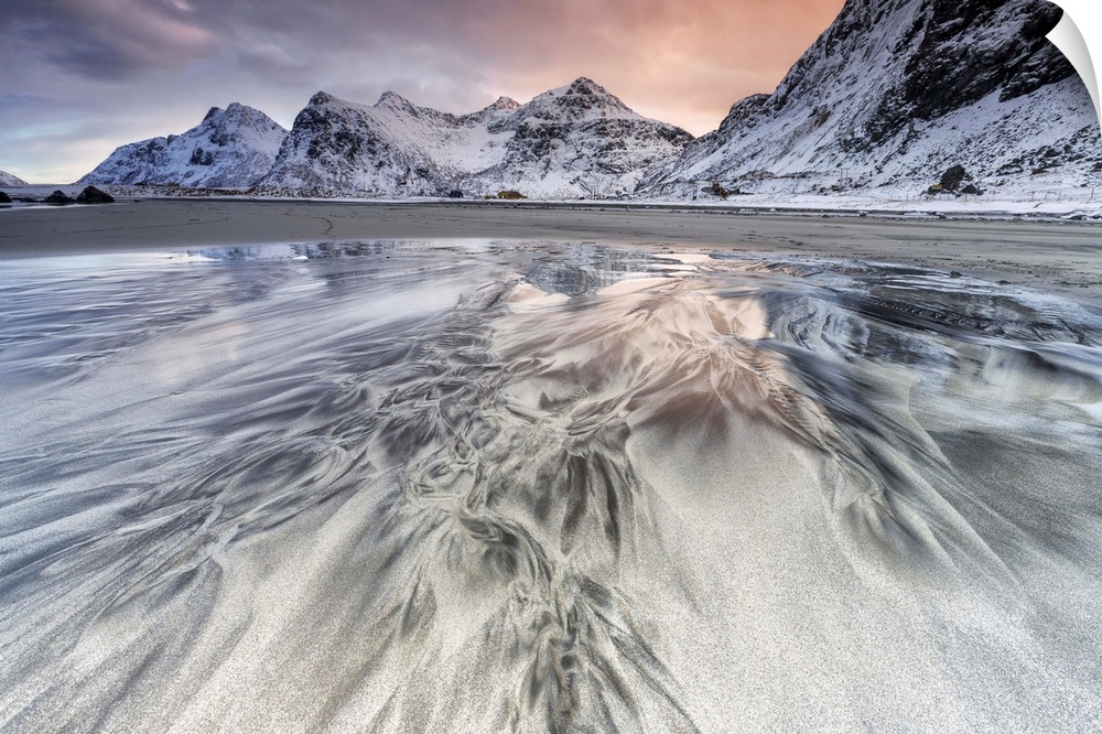 Sunset on the surreal Skagsanden beach surrounded by snow covered mountains, Flakstad, Lofoten Islands, Arctic, Norway, Sc...