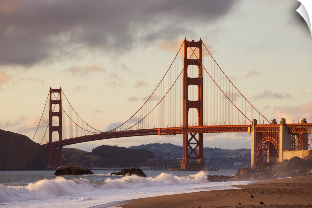 The Golden Gate Bridge, linking the city of San Francisco with Marin County, taken from Baker Beach at sunset and high tid...