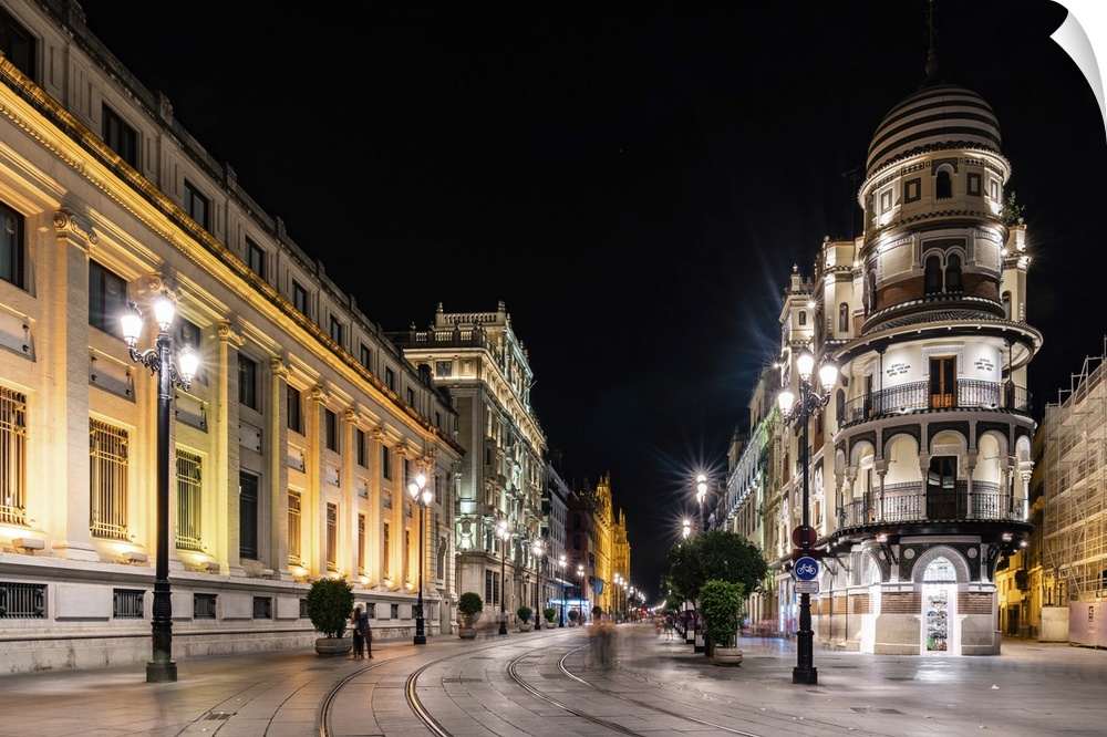 The lights of Seville's buildings at night looking down the Avenida de la Constitucion towards the Catedral de Sevilla, Se...