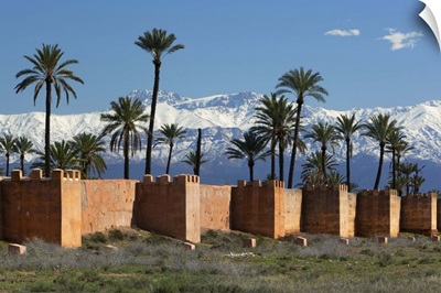 The old city walls and snow capped Atlas Mountains, Marrakech, Morocco, North Africa