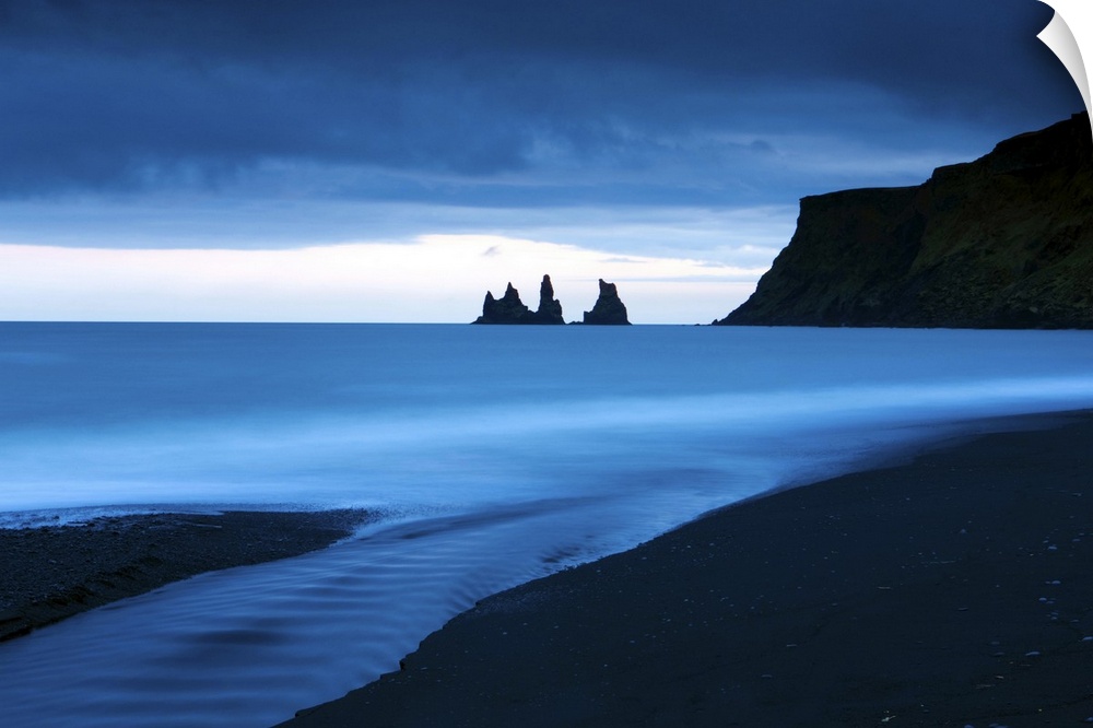 Twilight view towards rock stacks at Reynisdrangar off the coast at Vik, Iceland
