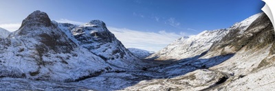 View down snow-covered Glencoe showing Three Sisters of Glencoe, Scotland