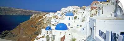 View of Oia with blue domed churches, Santorini, Greek Islands, Greece