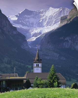 Village church and Oberer Grindelwald Glacier, Swiss Alps, Switzerland