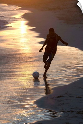 Young man playing football at sandbeach in twilight, Sal, Cape Verde, Africa