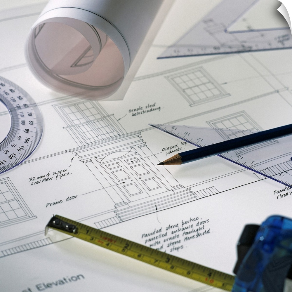 Architectural drawings and equipment used in the design of a house.