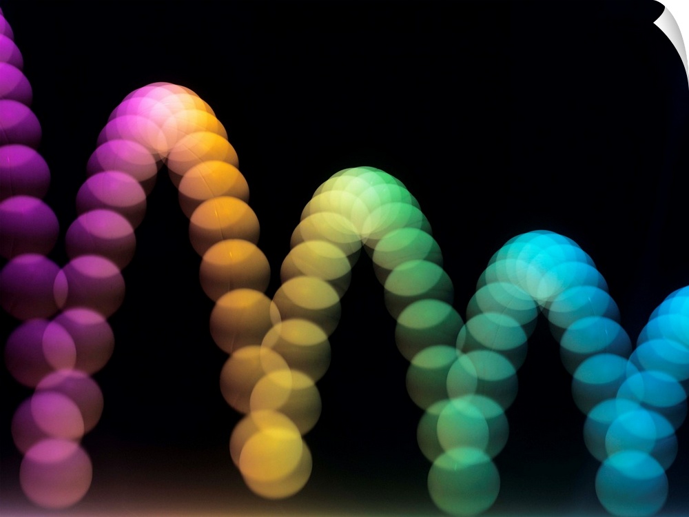 Bouncing ball, stroboscopic image using coloured lights. The strobe light was set to flash 50 times every second, and the ...