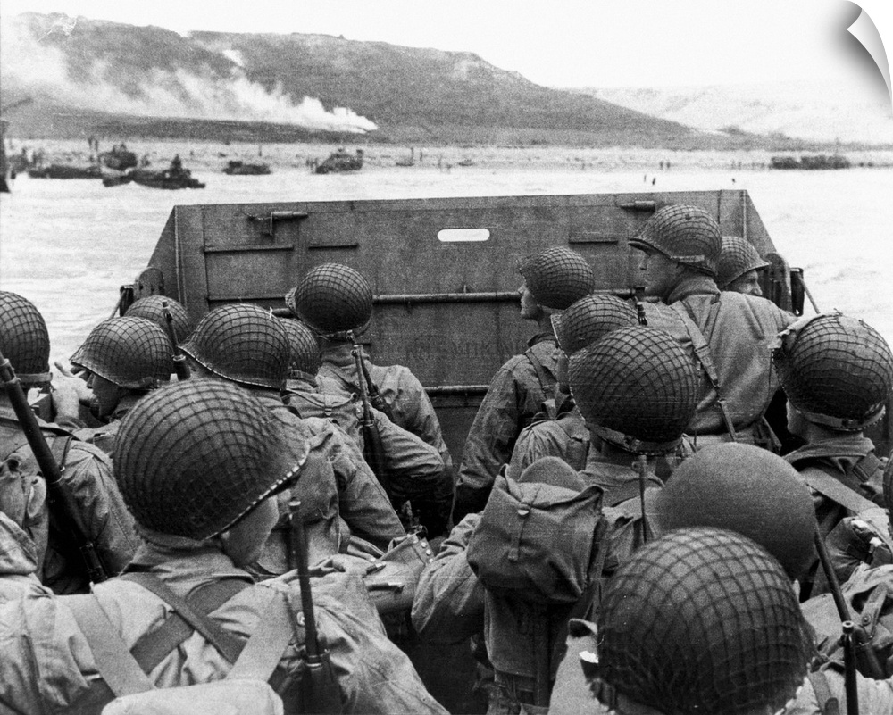 D-Day landings. US assault troops in a landing craft behind its protective shield as it nears a beachhead on the northern ...