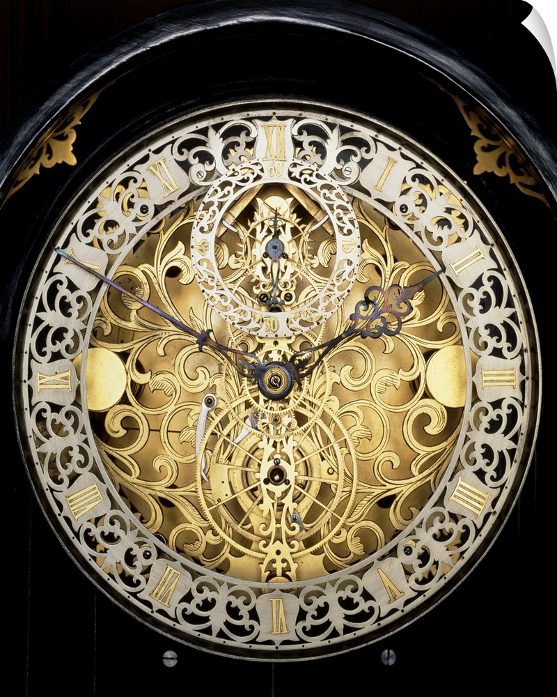 Antique clock. Face of an antique skeleton clock, revealing the internal gearing. The main face shows the time in hours an...