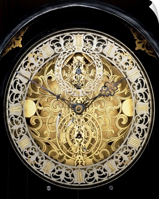 Face of an antique skeleton clock, showing gearing