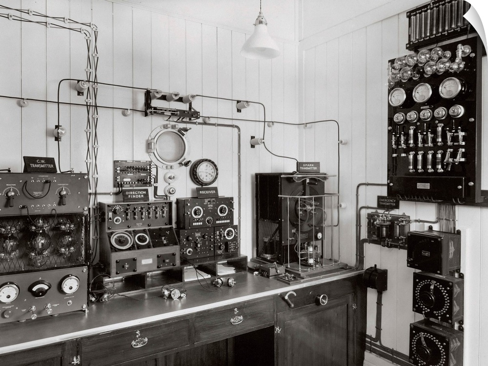 Marconi radio equipment on a ship. The equipment includes headphones and a Morse code key (lower centre). The equipment is...