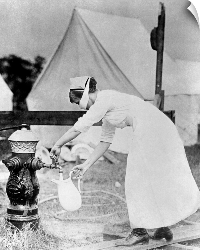 Nurse collecting water, while wearing a face mask, at a field hospital during the 1918 Spanish flu pandemic. The pandemic ...