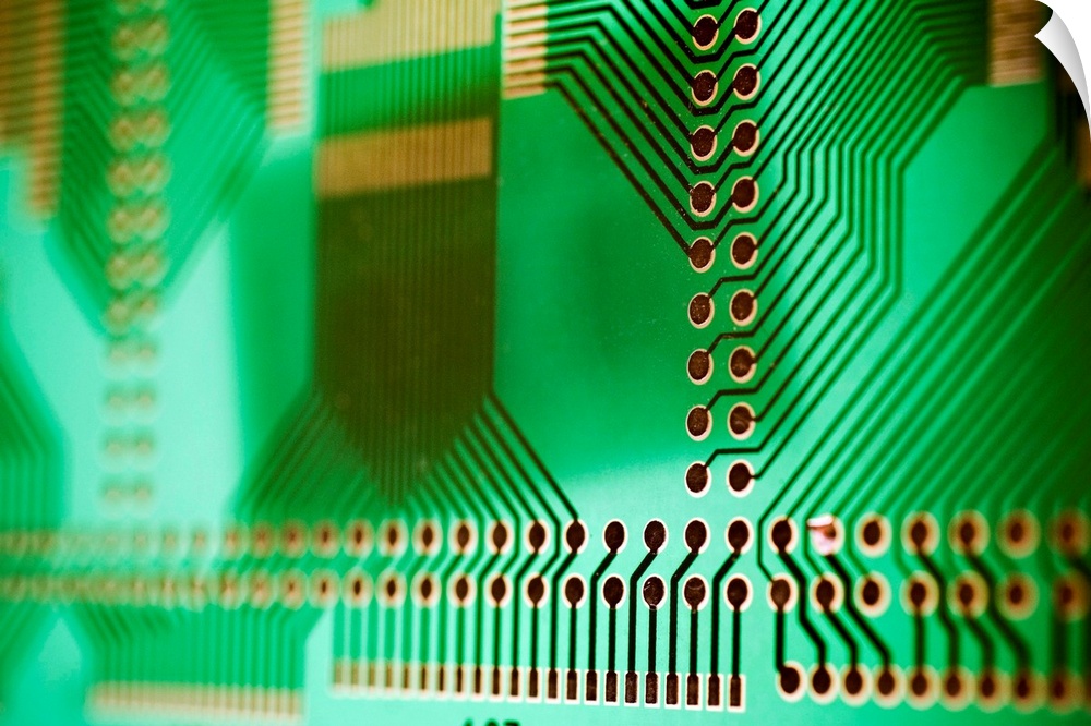 Printed circuit board (PCB), showing the holes into which component connections are inserted and soldered. The metal etchi...