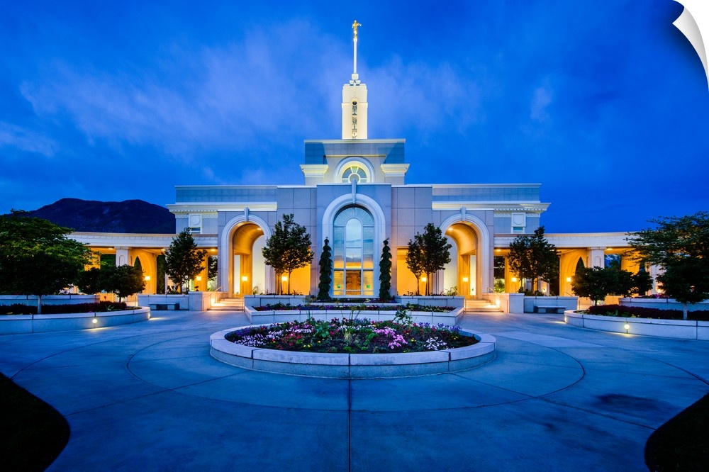 The Mount Timpanogos Utah Temple is located in American Fork, Utah. Its bright exterior offsets it from the hills behind i...