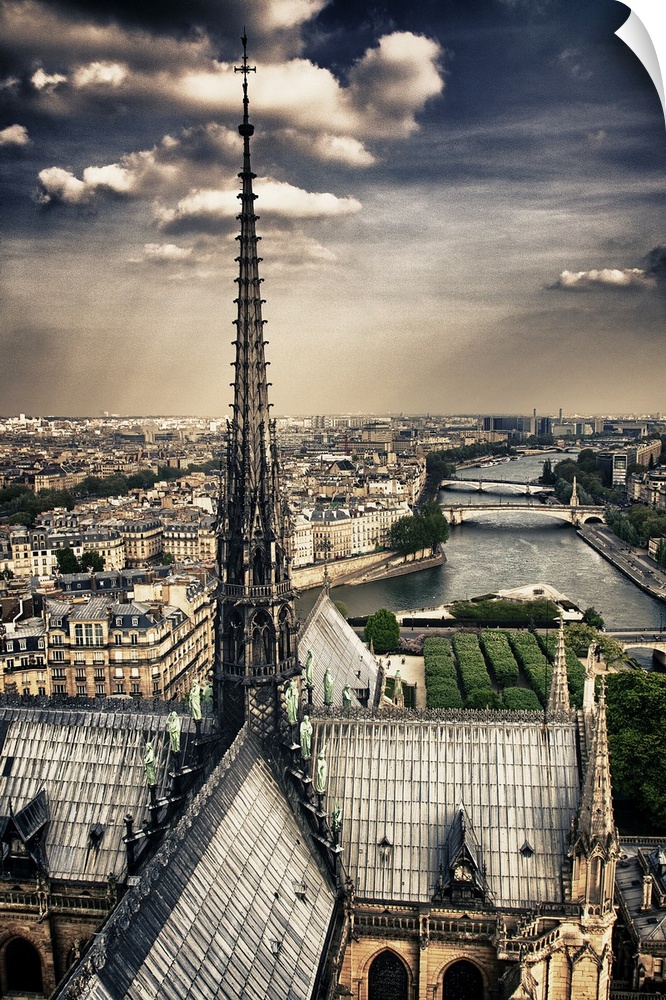 Fine art photograph of the top spire of the cathedral, overlooking the Seine river and the Ile-de-Paris on a cloudy day.