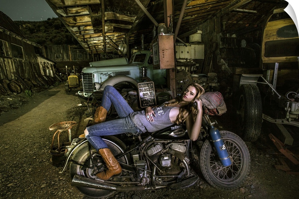Sexy blond laying on an old Harley Davidson