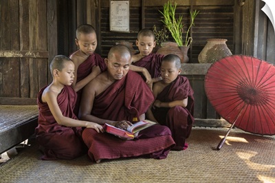Burmese monkmaster and young monks in their monastery