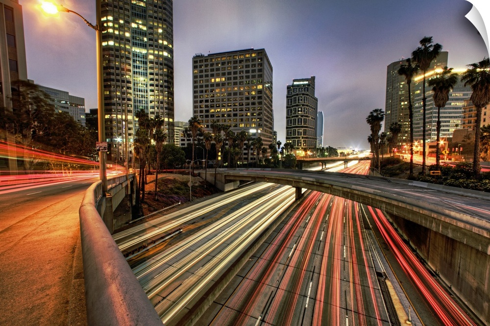 A large photograph of some of downtown Los Angeles with the lights of cars streaking through.