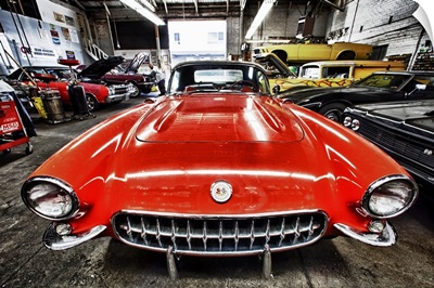 Classic red corvette in a car repair shop