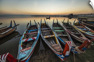 Colorful longtail boats at sunrise at the Ubein Bridge in Mandalay, Burma