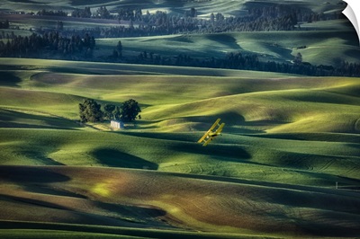 Crop Duster Flying Over The Rolling Wheat Fields Of The Palouse