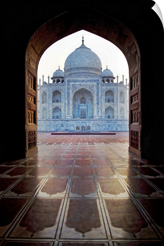 Photograph taken of the Taj Mahal through an archway.