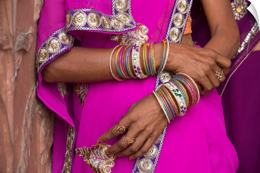 Jewelry on womans arms by the Taj Mahal in India.