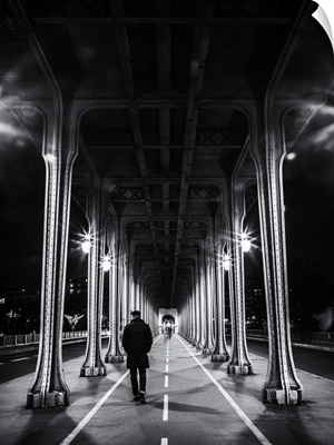 Man walking under overpass in Paris, France