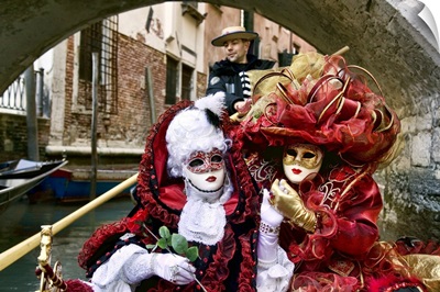 Masquerade time on gondola during Carnival, Venice, Italy