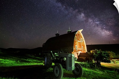 Milky Way over tractor and red barn in the Palouse