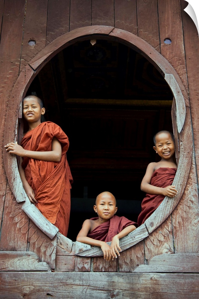 Monk boys in window of their monastery, Inle lake, Burma