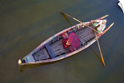 Monk in longtail boat in Mandalay, Burma