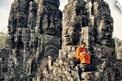 Monk reading atop temple, Angkor Wat, Cambodia