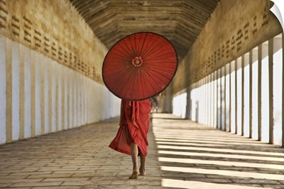 Monk with Parasol walking in Monastery, Bagan, Burma